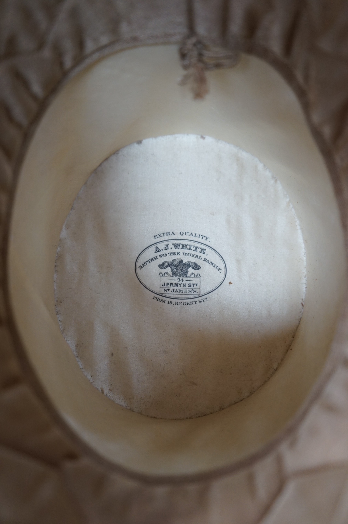 A pair of vintage leather riding boots and a leather cased top hat, ‘A.J. White, hatter to the Royal Family’. Condition - fair